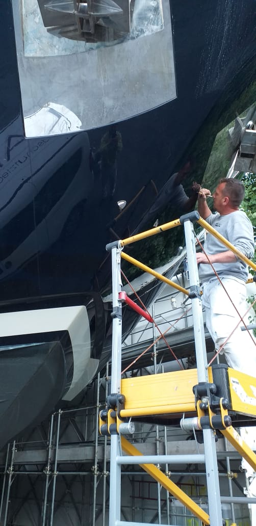 paint-technician-spot-repairing-luxury-yacht