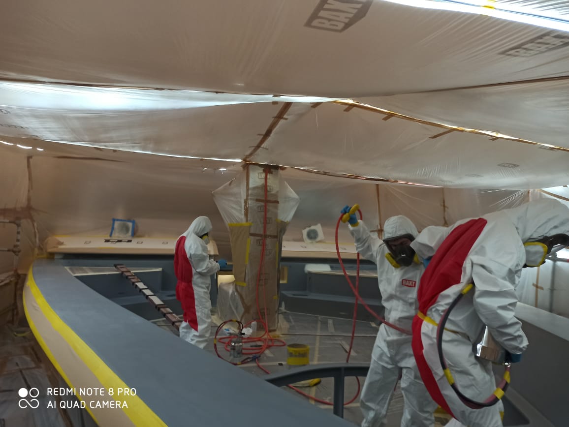 Yacht painter gang getting ready to spray coat